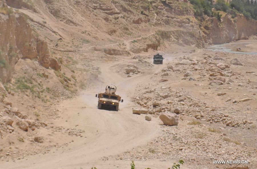 Afghan policemen patrol with their military vehicles during an operation against Taliban in Jawzjan province, northern Afghanistan, on July 24, 2013. (Xinhua/Arui)