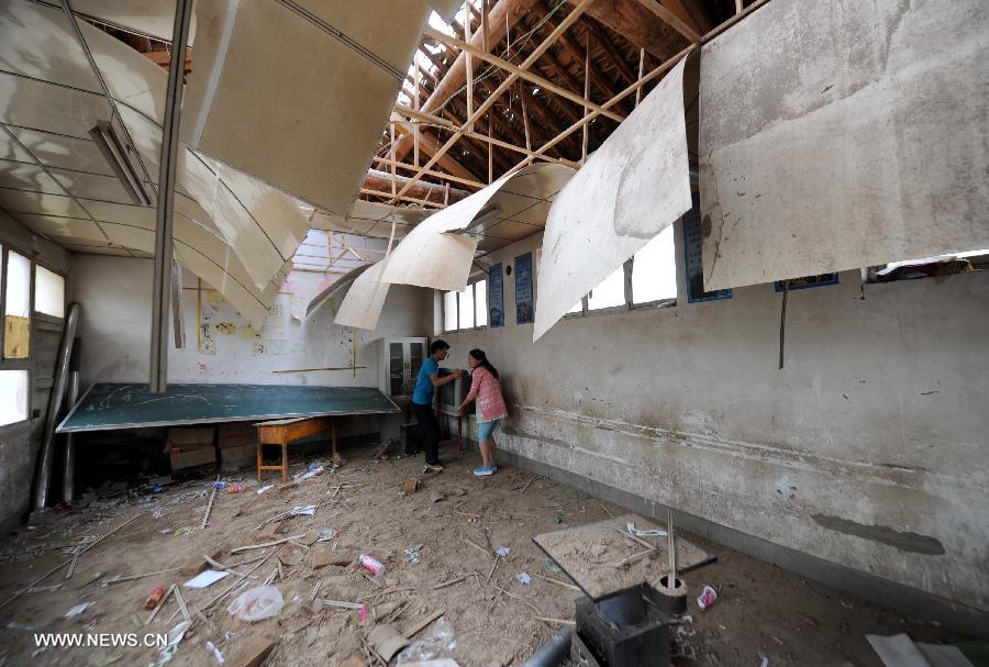 Photo taken on July 24, 2013 shows a damaged classroom of a primary school in the quake-hit Majiagou Village in Meichuan Township, Minxian County, northwest China's Gansu Province. Over 360 schools in Gansu's Minxian and Zhangxian counties were destroyed by the 6.6-magnitude quake that occurred on Monday, affecting 77,000 students, according to the local authorities. (Xinhua/Luo Xiaoguang)