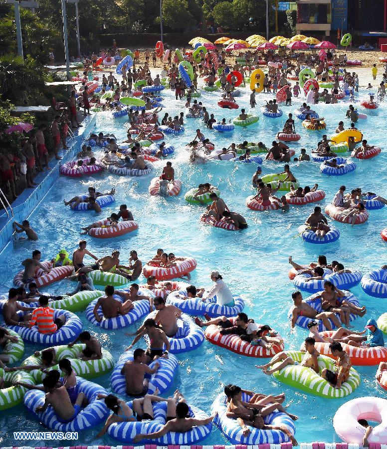 Residents play in a water park in east China's Shanghai, July 24. The highest temperature reached 40.8 degrees Celsius in some areas of Shanghai on Wednesday. (Xinhua/Ding Ting)