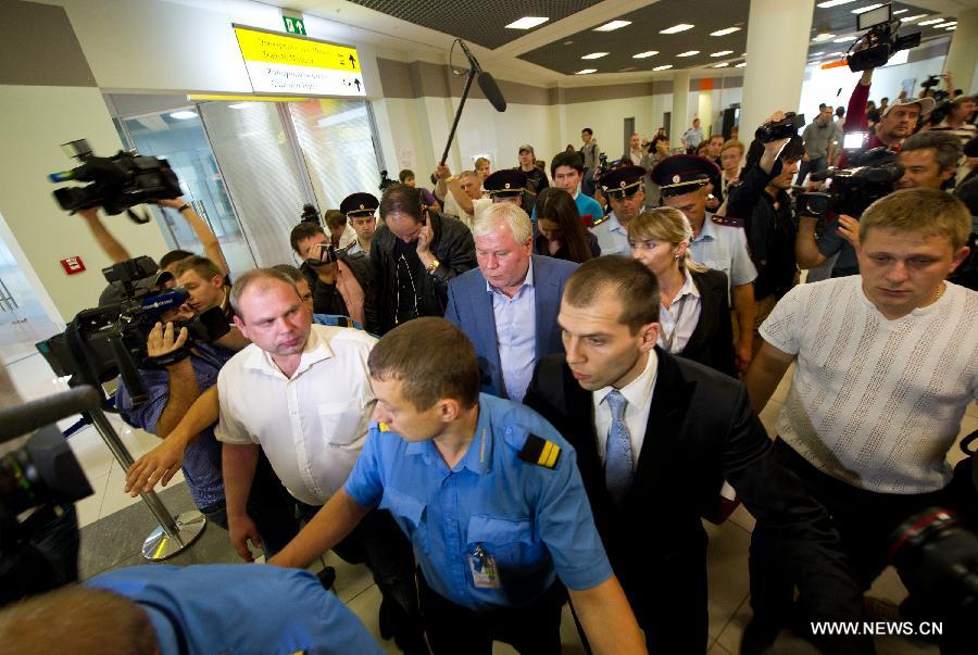 Lawyer Anatoly Kucherena (C) is surrounded by the media after meeting with fugitive U.S. intelligence whistleblower Edward Snowden at the Sheremetyevo Airport in Moscow, Russia, on July 24, 2013. Snowden can not leave the transit zone of the Sheremetyevo Airport as he was not granted a document from Russia's Federal Migration Service, a lawyer on behalf of Snowden said Wednesday. (Xinhua/Jiang Kehong)