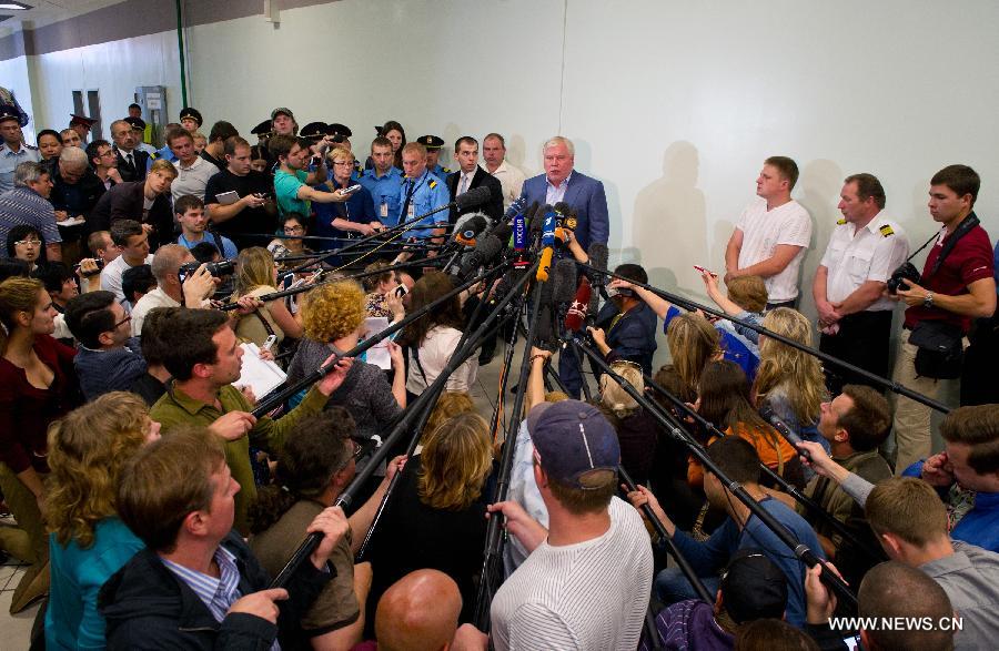 Lawyer Anatoly Kucherena (C) speaks to the media after meeting with fugitive U.S. intelligence whistleblower Edward Snowden at the Sheremetyevo Airport in Moscow, Russia, on July 24, 2013. Snowden can not leave the transit zone of the Sheremetyevo Airport as he was not granted a document from Russia's Federal Migration Service, a lawyer on behalf of Snowden said Wednesday. (Xinhua/Jiang Kehong)