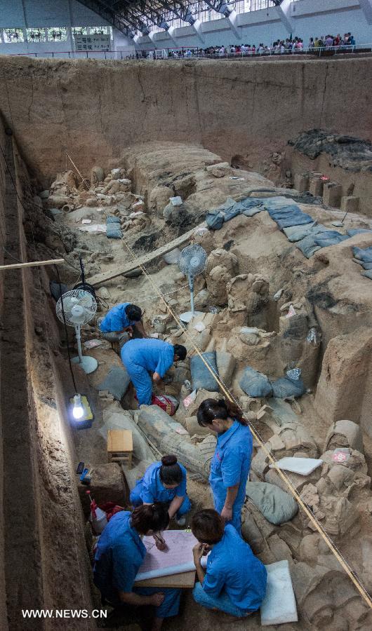Archeological workers make a sketch map at the No.1 Pit of the Emperor Qinshihuang's Mausoleum Site Museum in Xi'an, capital of northwest China's Shaanxi Province, July 18, 2013. The 2,200-year-old mausoleum was discovered in Lintong District, 35 km east of Xi'an, in 1974 by peasants who were digging a well. The Chinese terracotta army buried around the mausoleum was one of the greatest archeological finds of modern times. (Xinhua/Xue Yanwen) 