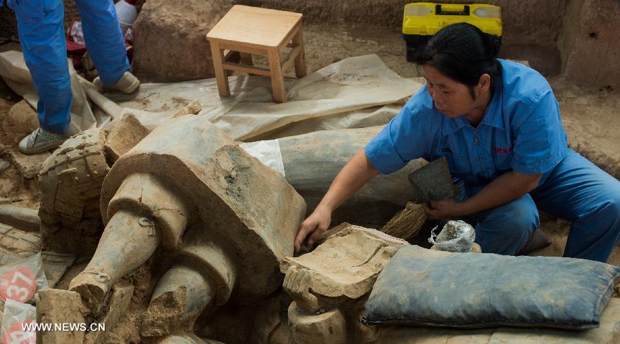 An archeological worker cleans pieces of excavated terracotta warriors at the Emperor Qinshihuang's Mausoleum Site Museum in Xi'an, capital of northwest China's Shaanxi Province, July 18, 2013. The 2,200-year-old mausoleum was discovered in Lintong District, 35 km east of Xi'an, in 1974 by peasants who were digging a well. The Chinese terracotta army buried around the mausoleum was one of the greatest archeological finds of modern times. (Xinhua/Xue Yanwen) 