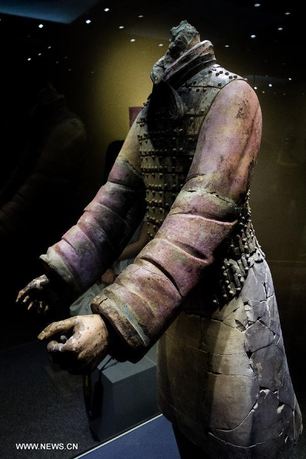 A terracotta warrior, whose original purple embellishment remained intact after repair work, is on display at the Emperor Qinshihuang's Mausoleum Site Museum in Xi'an, capital of northwest China's Shaanxi Province, July 18, 2013. The 2,200-year-old mausoleum was discovered in Lintong District, 35 km east of Xi'an, in 1974 by peasants who were digging a well. The Chinese terracotta army buried around the mausoleum was one of the greatest archeological finds of modern times. (Xinhua/Xue Yanwen)
