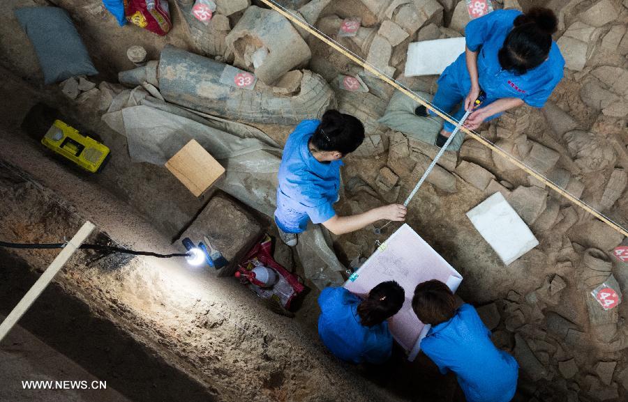 Archeological workers make a sketch map at the No. 1 Pit of the Emperor Qinshihuang's Mausoleum Site Museum in Xi'an, capital of northwest China's Shaanxi Province, July 18, 2013. The 2,200-year-old mausoleum was discovered in Lintong District, 35 km east of Xi'an, in 1974 by peasants who were digging a well. The Chinese terracotta army buried around the mausoleum was one of the greatest archeological finds of modern times. (Xinhua/Bi Xiaoyang) 