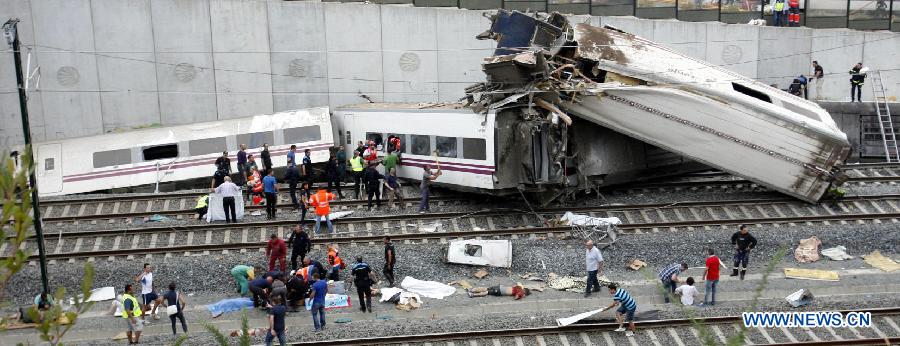 Rescuers and citizens work at the site where a train crashed, at the entrance of Santiago de Compostela Station, in the autonomous community of Galicia, northwest of Spain, on July 24, 2013. Up to 35 people have died and around 100 injured after a train derailed just outside the city of Santiago de Compostela in the region of Galicia in north-western Spain on Wednesday evening. (Xinhua/Oscar Corral)