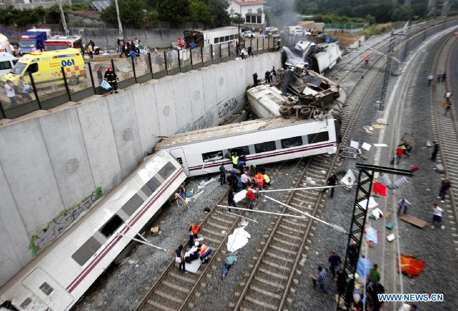 Rescuers and citizens work at the site where a train crashed, at the entrance of Santiago de Compostela Station, in the autonomous community of Galicia, northwest of Spain, on July 24, 2013. Up to 35 people have died and around 100 injured after a train derailed just outside the city of Santiago de Compostela in the region of Galicia in north-western Spain on Wednesday evening. (Xinhua/Oscar Corral)