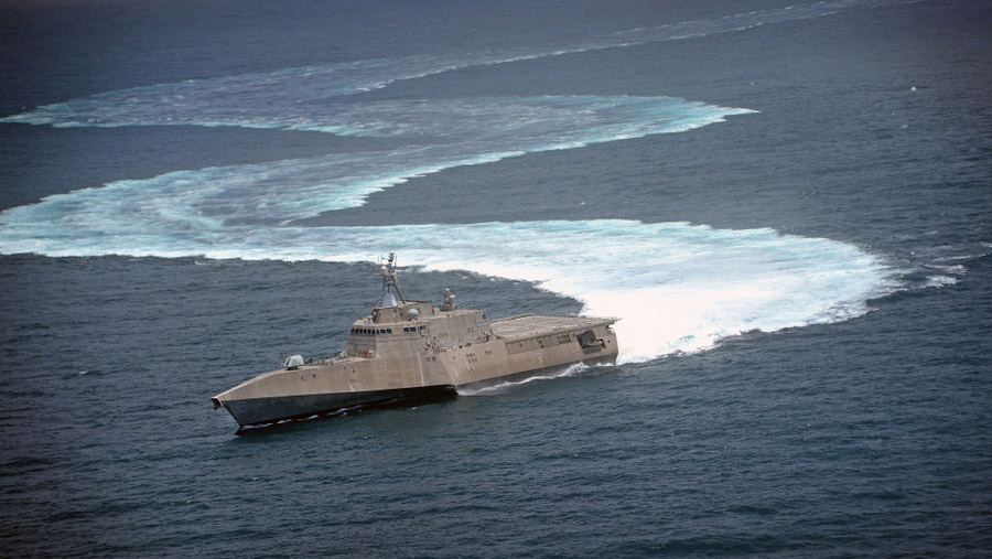 The littoral combat ship USS Independence (LCS 2) demonstrates its maneuvering capabilities in the Pacific Ocean off the coast of San Diego.  The littoral combat ship (LCS) is a class of relatively small surface vessels intended for operations in the littoral zone (close to shore) by the United States Navy. It can be fitted with interchangeable mission packages such as surface warfare, minesweeping and anti-submarine warfare.  (Source: cri.cn)