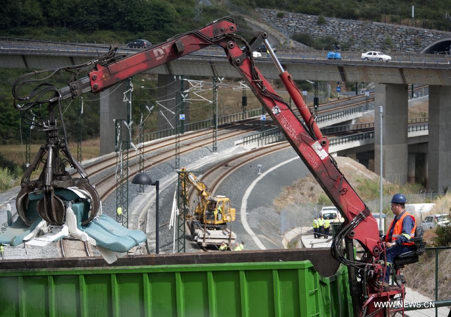 Rescuers work at the accident site at the entrance of Santiago de Compostela Station, in the autonomous community of Galicia, northwest of Spain, on July 25, 2013. The death toll has risen to at least 80 after a train derailed outside the city of Santiago de Compostela on late July 24, according to the police. (Xinhua/Xie Haining)