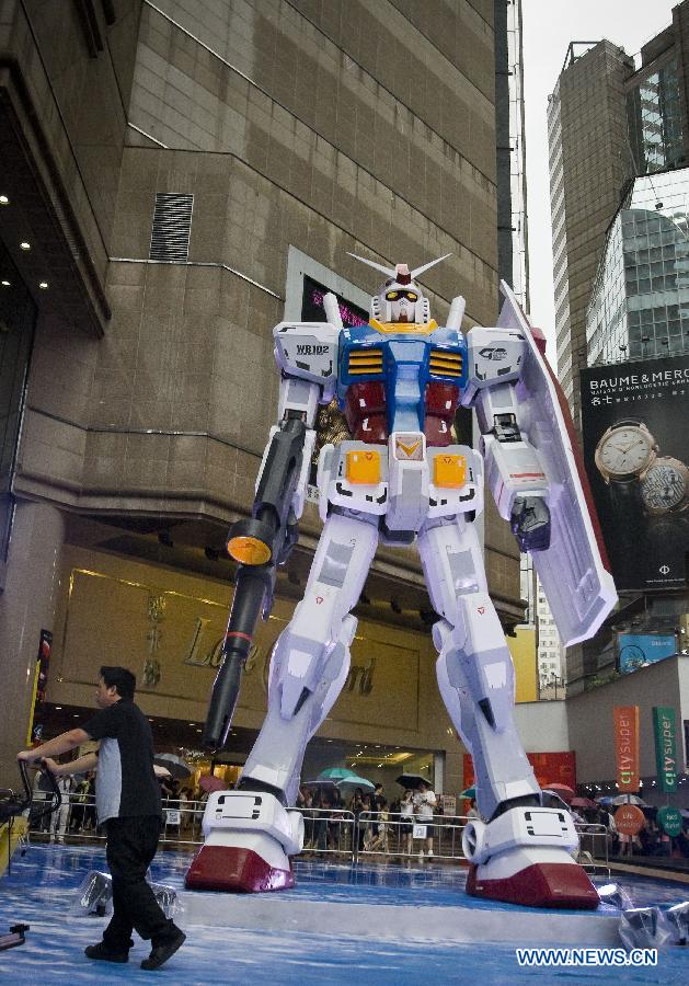 A six-meter-tall model of a "Gundam" robot in Japan's TV animation is set up in Hong Kong, south China, July 25, 2013. The exhibition "Gundam Docks at Hong Kong" held its opening event here on Thursday, showcasing some 100 "Gundam" models. (Xinhua/He Jingjia)