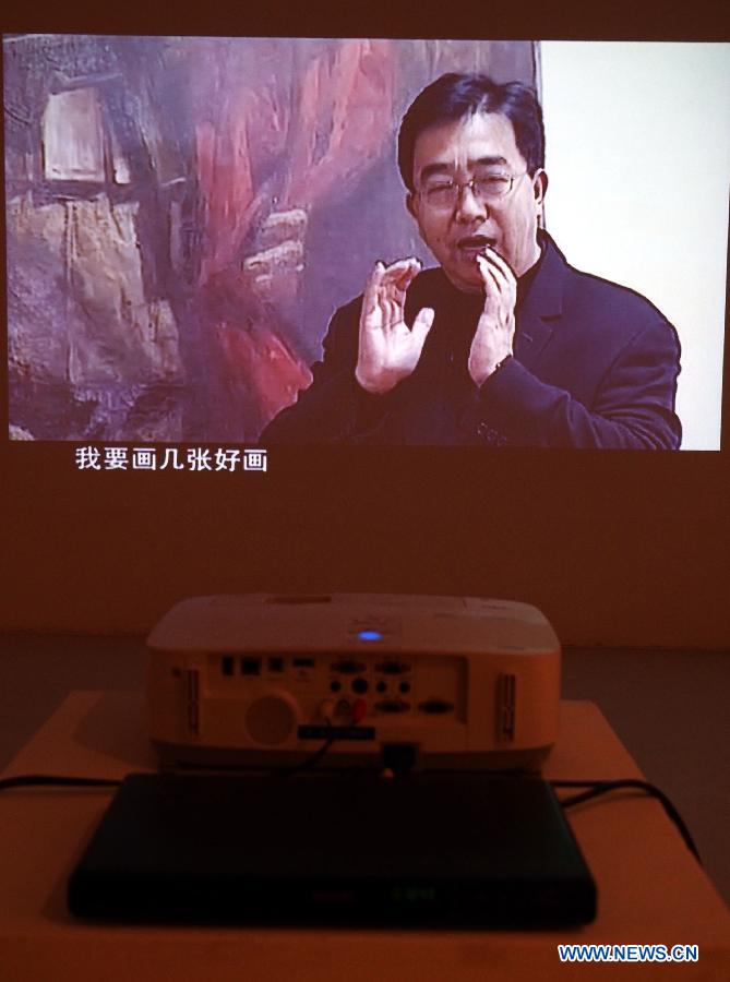 A video of late Chinese artist Chen Yifei is played in Shanghai Oil Painting and Sculpture Institute, east China's Shanghai, July 25, 2013. An exhibition about the life and the works of Chen Yifei, one of China's most acclaimed painters and visual artists who died in 2005, is opened in the institute on Thursday. (Xinhua/Ren Long)