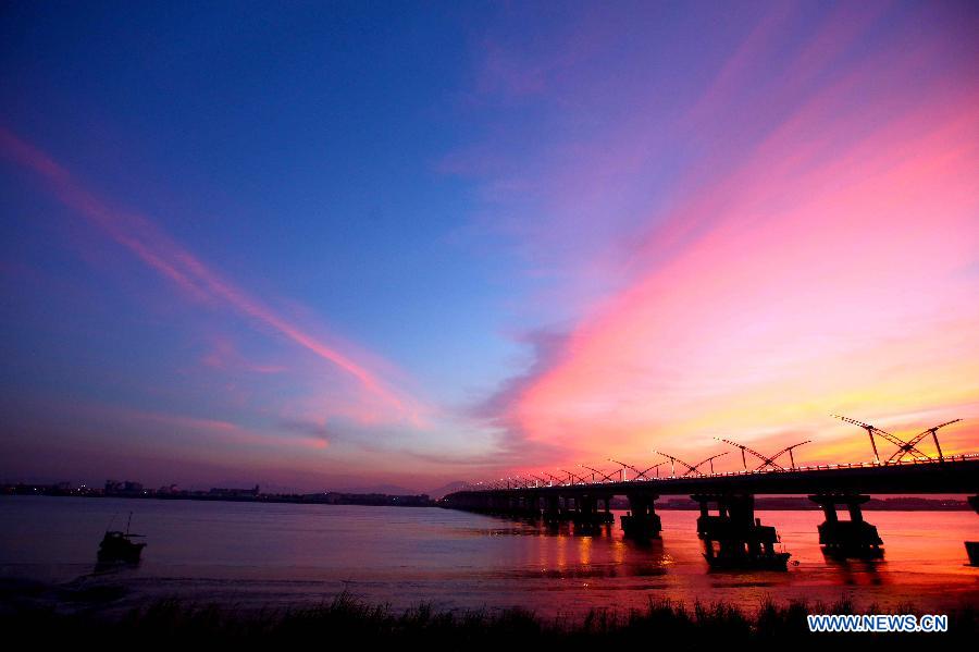 Photo taken on July 25, 2013 shows the Feiyunjiang Bridge under colorful sunset glow after continuous scorching weather in Rui'an City, east China's Zhejiang Province. (Xinhua/Zhuang Yingchang)