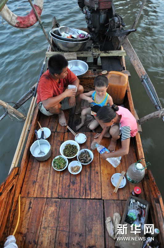 Yi, Chen and their son have dinner at the stern. (Photo by Long Hongtao/ Xinhua)