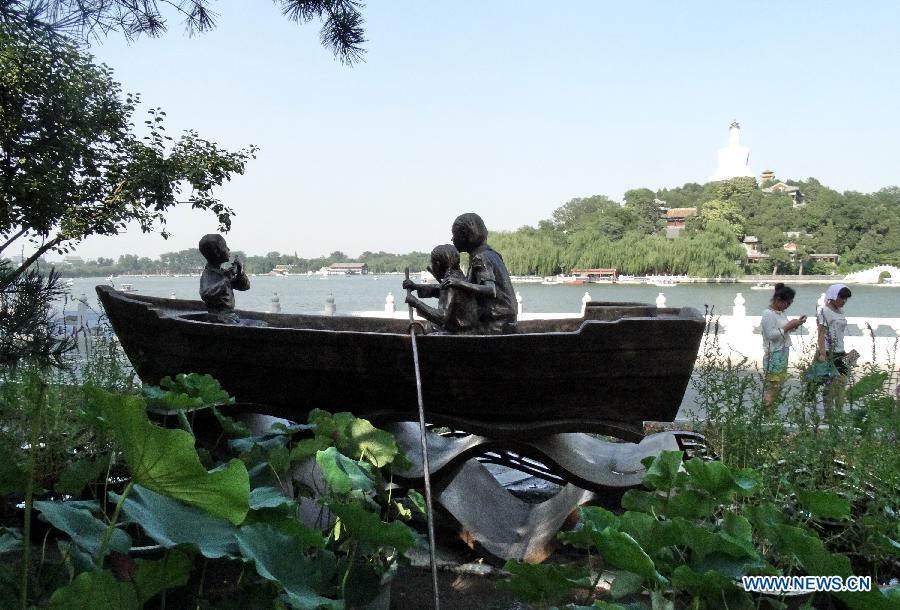A sculpture named "Let us sway twin oars" is seen at the Beihai Park in Beijing, capital of China, July 25, 2013. The sculpture is in memory of a Chinese popular song of the same name. (Xinhua/Li Xin)