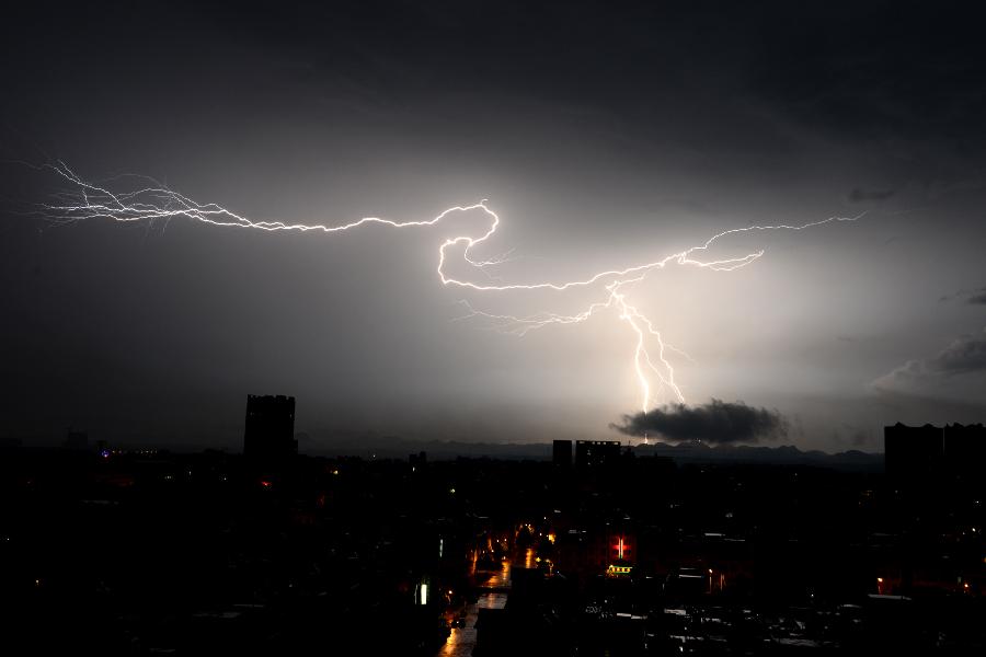 Lightning is seen over the county seat of Luoping in southwest China's Yunnan Province, July 26, 2013. A heavy rainfall hit Luoping County on Friday. (Xinhua/Mao Hong) 