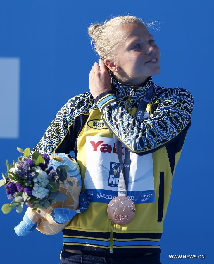 Iuliia Prokopchuk of Ukraine reacts during the awarding ceremony for the Women's 10m Platform Final of the Diving competition in the 15th FINA World Championships at the Piscina Municipal de Montjuic in Barcelona, Spain on July 25, 2013. Iuliia Prokopchuk took the bronze with a total score of 358.40 points. (Xinhua/Wang Lili)
