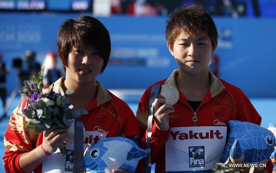 Gold medalist Si Yajie (R) of China and silver medalist Chen Ruolin of China pose during the awarding ceremony for the Women's 10m Platform Final of the Diving competition in the 15th FINA World Championships at the Piscina Municipal de Montjuic in Barcelona, Spain on July 25, 2013. Si claimed the title with a total score of 392.15 points. (Xinhua/Wang Lili)