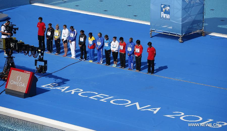 Competitors observe one-minute silence in honor of the Galicia rail derailment on Wednesday ahead of the Women's 10m Platform Final of the Diving competition in the 15th FINA World Championships at the Piscina Municipal de Montjuic in Barcelona, Spain on July 25, 2013. (Xinhua/Wang Lili)