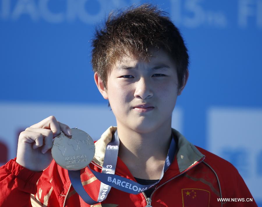 Si Yajie of China shows her gold medal during the awarding ceremony for the Women's 10m Platform Final of the Diving competition in the 15th FINA World Championships at the Piscina Municipal de Montjuic in Barcelona, Spain on July 25, 2013. Si claimed the title with a total score of 392.15 points. (Xinhua/Wang Lili)