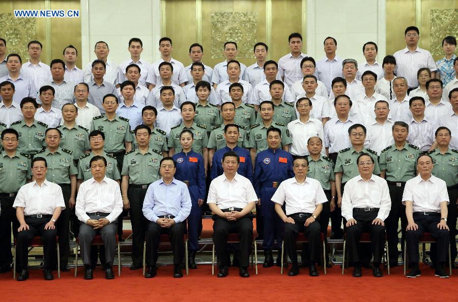 China's top leaders Xi Jinping (C front), Li Keqiang (3rd R front), Zhang Dejiang (3rd L front), Yu Zhengsheng (2nd R front), Liu Yunshan (2nd L front), Wang Qishan (1st R front) and Zhang Gaoli (1st L front) meet with astronauts and scientists who participated in the Shenzhou-10 mission, at the Great Hall of the People in Beijing, capital of China, July 26, 2013. (Xinhua/Lan Hongguang) 