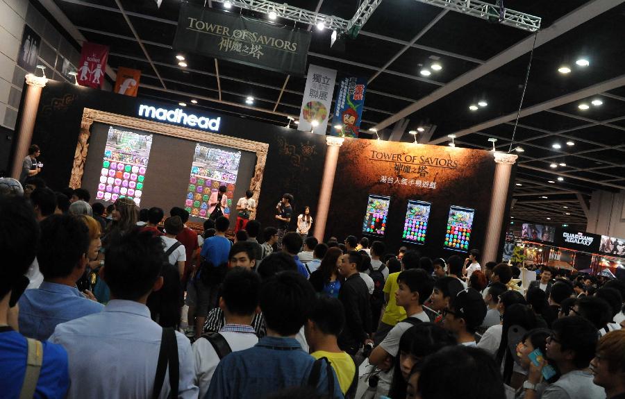 People visit a pavilion showcasing mobile phone game at the Animation, Comics & Games Expo in Hong Kong (ACGHK), south China, July 26, 2013. The five-day ACGHK, starting here Friday, is expected to attract some 700,000 visitors. (Xinhua/Zhao Yusi) 