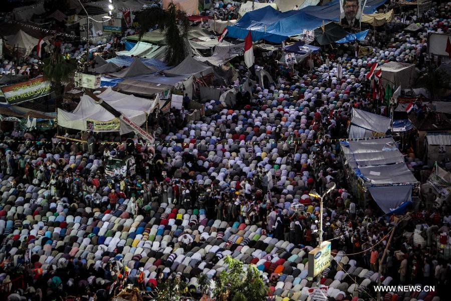 Supporters of Egypt's ousted President Mohamed Morsi pray during a protest in Rabaa Al-Adaweya Square for the 29th day in row, Cairo, July 26, 2013. A top Egyptian court has ordered the detention of ousted Islamist-oriented President Mohamed Morsi for 15 days for investigations over charges of spying and jailbreak, official media reported Friday. (Xinhua/Amru Salahuddien) 