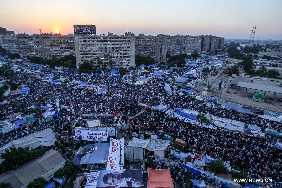 Supporters of Egypt's ousted President Mohamed Morsi take part in a protest in Rabaa Al-Adaweya Square for the 29th day in row, Cairo, July 26, 2013. A top Egyptian court has ordered the detention of ousted Islamist-oriented President Mohamed Morsi for 15 days for investigations over charges of spying and jailbreak, official media reported Friday. (Xinhua/Amru Salahuddien) 