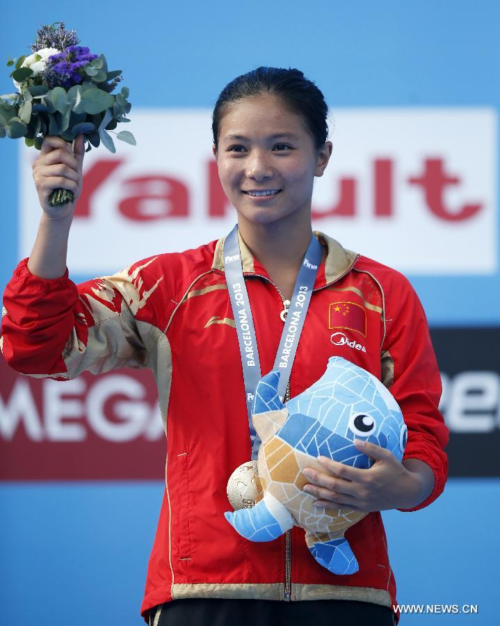 China's He Zi reacts during the awarding ceremony for Women's 3m Springboard diving at the 15th FINA World Championships in Barcelona, Spain, on July 27, 2013. He Zi claimed the title with a total score of 383.40 points. (Xinhua/Wang Lili) 