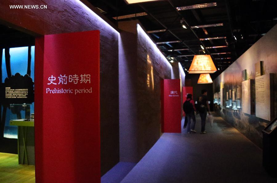 People visit the Hong Kong Heritage Discovery Centre in Hong Kong, south China, July 27, 2013. By occupying and restoring the historic building of a former British barrack, the centre has opened to the public since 2005 for antiquities exhibition and education use. (Xinhua/Li Peng) 