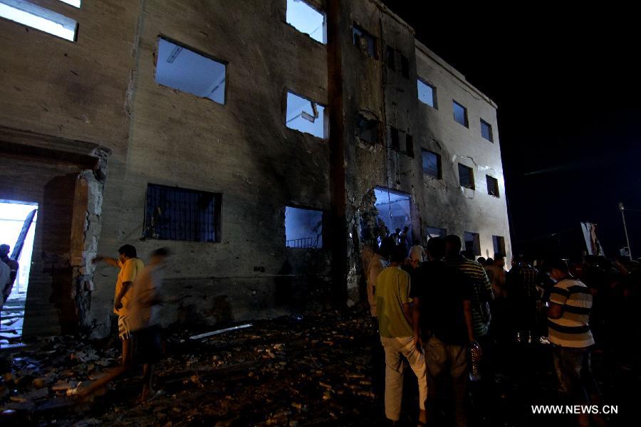 People gather at an explosion site in Benghazi, Libya, July 28, 2013. Two courthouses in Libya's eastern city of Benghazi were hit by explosions on Sunday night, leaving 13 people injured and causing property damage, security sources told Xinhua. (Xinhua)