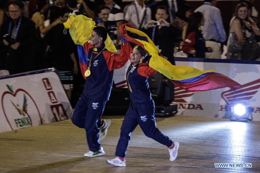 Colombian atlhetes Jefferson Benjumea (L) and Adriana Davila react after winning the gold in the Sports Dancing on Salsa category during the IX World Games 2013 in Caly City, Colombia, on July 28, 2013. (Xinhua/Jhon Paz)