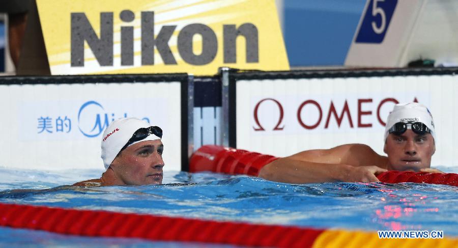 Ryan Lochte (L) of the United States looks at the screen after Men's 200m Freestyle Heats of the Swimming competition on day 10 of the 15th FINA World Championships at Palau Sant Jordi in Barcelona, Spain on July 29, 2013. Ryan Lochte advanced to the semifinal with 1:47.90. (Xinhua/Wang Lili)