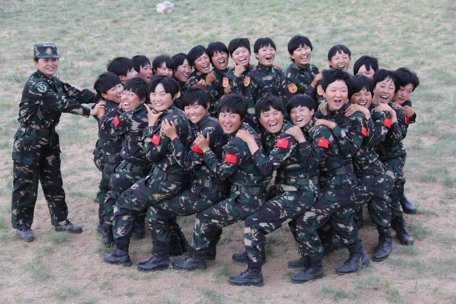 Female soldiers play games during a psychological test at the Zhurihe training base in north China's Inner Mongolia Autonomous Region, July 18, 2013. The first female special forces unit established by the Chinese People's Liberation Army received intensive training as the Army Day is coming. The youngest soldier of the unit is 18 years old while the oldest one is 26. All of the female soldiers have college degrees or above and have been trained to master special combat skills. (Xinhua/Wang Jianmin)