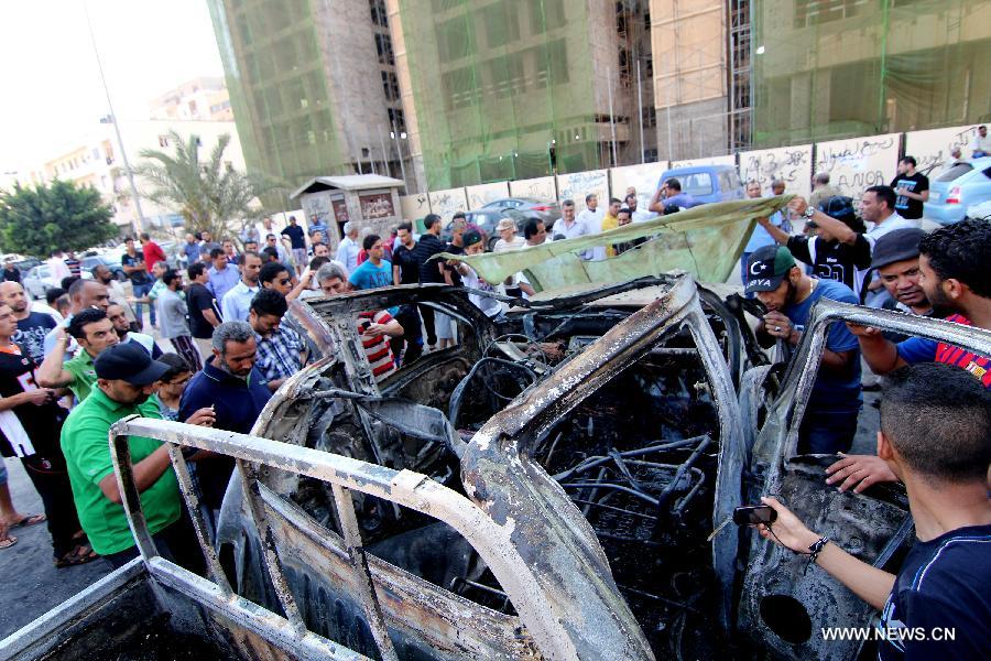 People gather at a site of blast in Libya's eastern city of Benghazi, July 29, 2013. A blast hit Benghazi on Monday, a day after two explosion took place in the city, leaving one injured and a Libyan army vehicle destroyed. (Xinhua)