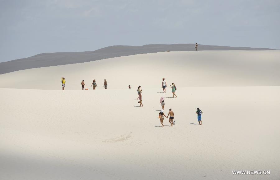 People visit Lencois Maranhenses National Park located in northeast Brazil's Maranhao state, July 28, 2013. At the end of rain season every year, crystal clear lagoons form in the desert here.(Xinhua/Weng Xinyang)