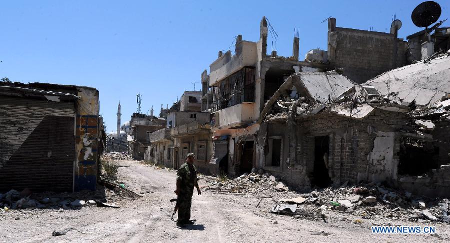 A soldier of the Syrian army patrols in the street of al-Khalidieh district in central Homs province, Syria, July 30, 2013. The Syrian army announced Monday that its troops successfully regained full control over the strategic al-Khalidieh district in central Homs province after a series of precise operations there, according to the state-TV. (Xinhua/Zhang Naijie)