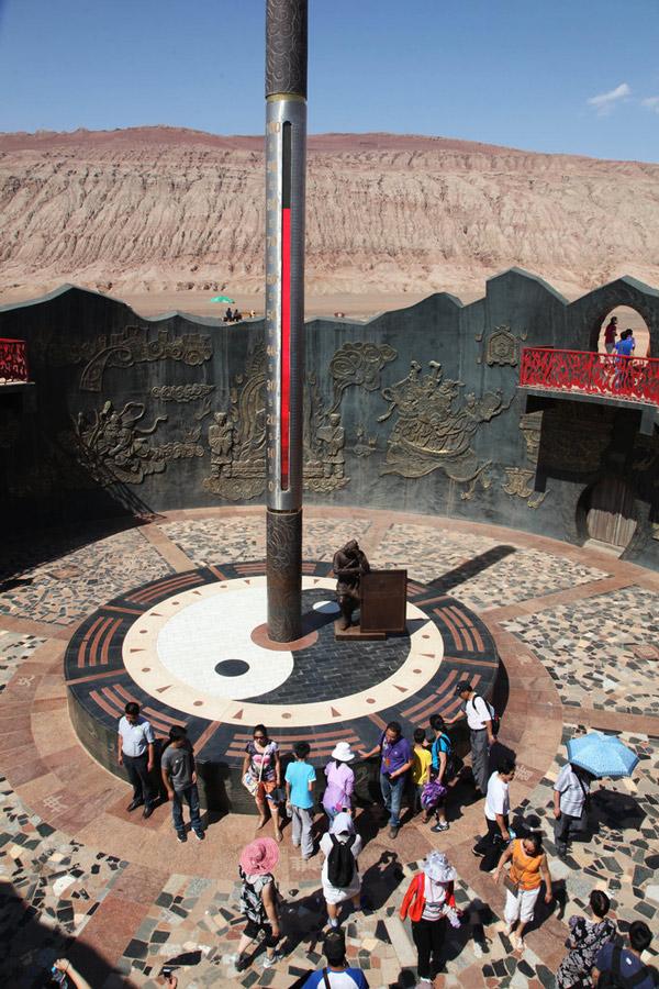 Tourists visit Huoyan mountain of Turpan city to the southeast of Urumqi, capital city of Xinjiang Uygur Autonomous Region of China on July 30, 2013. The giant thermometer in the Huoyan mountain of Turpan showed the temperature surpassed 78 degrees Celsius. (Photo/gmw.cn)