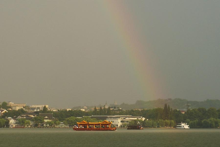 Photo taken on July 30, 2013 shows the rainbow over the sky above the West Lake in Hangzhou, capital of east China's Zhejiang Province. Hangzhou City underwent a rainmaking on Tuesday afternoon. (Xinhua/Li Zhong)