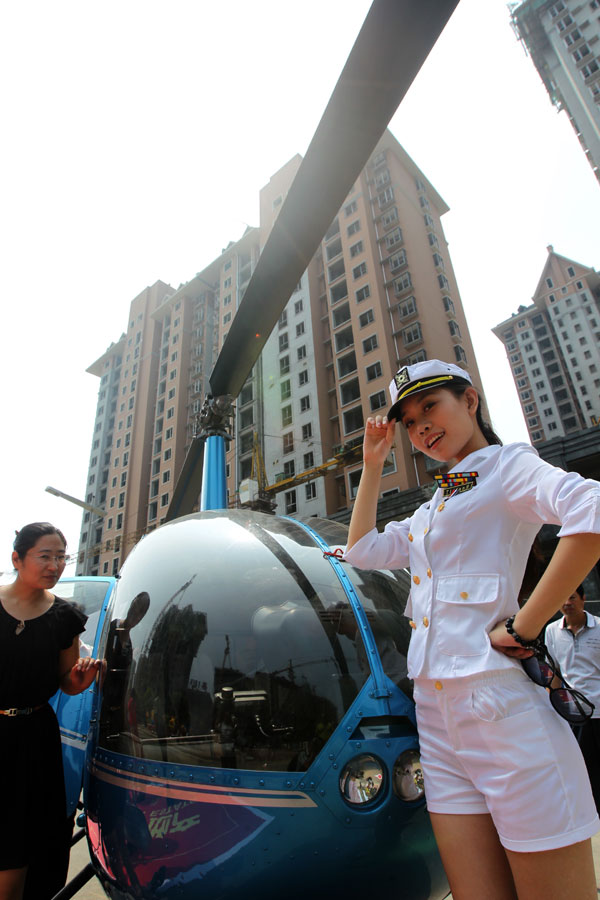 Two models were on hand for a private helicopter show, staged for the launch of a property project in Xuchang, Henan province. Professional flight crews also showed up to deliver live commentary at the event on Sunday. [Photo / China Daily]