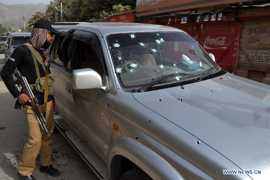 A policeman inspects a damaged vehicle at firing site in southwest Pakistan's Quetta on July 31, 2013. At least three people were killed and five others injured as unknown gunmen opened fire on a vehicle at Prince Road in Quetta on Wednesday, local media reported. (Xinhua/Asad)