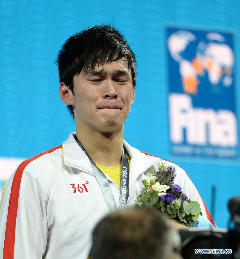 Sun Yang of China reacts during the awarding ceremony of the men's 800m freestyle final of the swimming competition at the 15th FINA World Championships in Barcelona, Spain on July 31, 2013. Sun Yang won the gold medal with 7 minutes and 41.36 seconds. (Xinhua/Guo Yong)