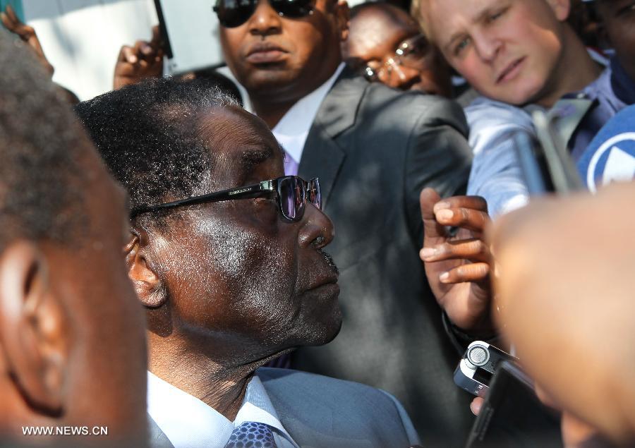 Zimbabwe's incumbent President and presidential candidate of Zimbabwe African National Union-Patriotic Front (Zanu-PF) Robert Mugabe receives an interview after casting his ballot at a polling station in Harare, capital of Zimbabwe, July 31, 2013. Robert Mugabe, Africa's oldest leader at 89, said Wednesday that he will serve a full five-year term if re-elected into the office. A total of 6.4 million registered voters in Zimbabwe lined up to cast their ballots at 9,735 polling stations on Wednesday to choose a president, legislators and local councilors. (Xinhua/Meng Chenguang)