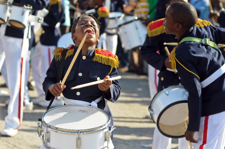 Members of a Haitian band participate in the Carnival of the Flowers of Haiti, in Port au Prince downtown, capital of Haiti, on July 31, 2013. Carnival of the Flowers of Haiti second edition, which convened thousands of people, bands, floats and costumed groups, was closed on Wednesday in the Haitian capital. (Xinhua/Swoan Parker)