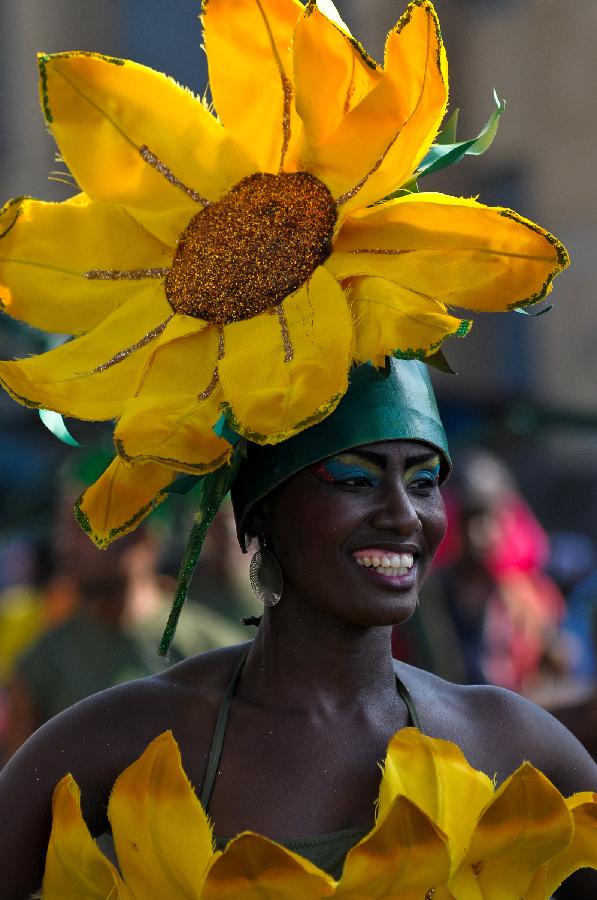 A Haitian group member participates with a clolorful costume in the Carnival of the Flowers of Haiti, in Port au Prince downtown, capital of Haiti, on July 31, 2013. Carnival of the Flowers of Haiti second edition, which convened thousands of people, bands, floats and costumed groups, was closed on Wednesday in the Haitian capital. (Xinhua/Swoan Parker)