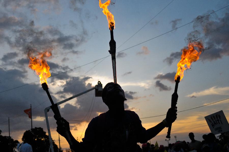 A Haitian reveler participates in the Carnival of the Flowers of Haiti, in Port au Prince downtown, capital of Haiti, on July 31, 2013. Carnival of the Flowers of Haiti second edition, which convened thousands of people, bands, floats and costumed groups, was closed on Wednesday in the Haitian capital. (Xinhua/Swoan Parker)