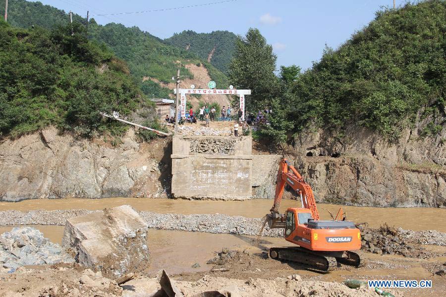 A bridge is damaged by the flood in Niangniangba Town, Qinzhou District of Tianshui City, northwest China's Gansu Province, July 31, 2013. More than 20 people were dead or missing and about 1.22 million people were affected by the landslides and floods caused by strong rainfall in Tianshui in recent days. (Xinhua/Bai Liping)