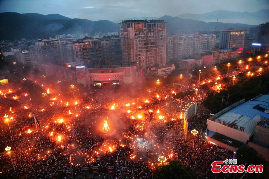 People celebrate the Torch Festival at Xichang of Southwest China’s Sichuan province on August 1, 2013. According to official statistics, yesterday’s activity attracted over 180,000 participants. The Torch Festival, which falls around the 24th day of the sixth Chinese lunar month every year, is a traditional carnival for the Yi ethnic group. (Photo/Gao Han)