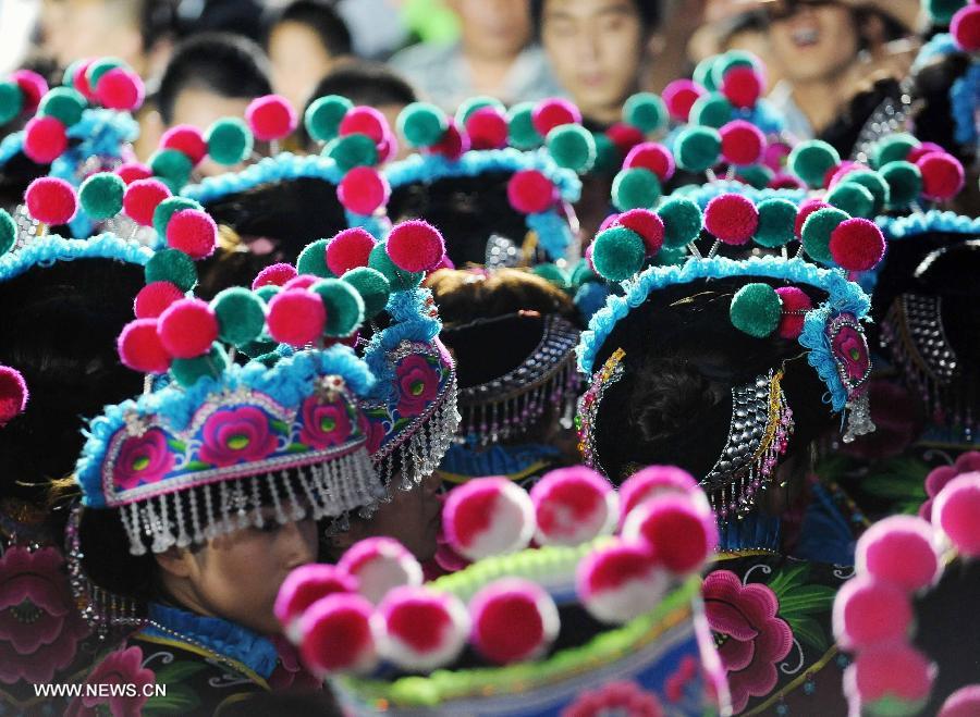 Photo taken on Aug. 1, 2013 shows women of Yi ethnic group wearing headgear attending the Torch Festival celebration in Chuxiong Yi Autonomous Prefecture, southwest China's Yunnan Province. The 2013 China (Chuxiong) Torch Festival of the Yi Ethnic Group was held here in recent days, in which the Yi people sang and danced in their colourful traditional clothing broidered by hands. (Xinhua/Yang Zongyou)