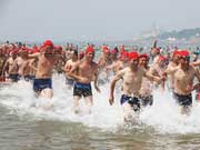 People celebrate National Fitness Day on Qingdao beach 