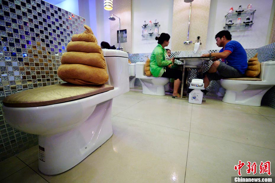 A toilet-themed restaurant opened in Taiyuan, north China’ Shanxi province on Aug. 28, 2013. Everything in the restaurant is absolutely toilet related; food and drink are served from mini toilet bowl or urinals; diners seat on toilet seats; toilet paper rolls are hung on the wall to replace table tissues. The decoration in toilet style offers a funny dining experience, which attracted lots young people to visit. (Photo/CNS)